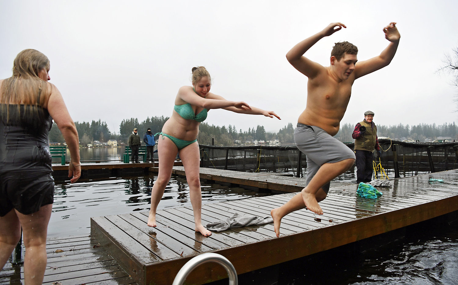 With a little help from his plungemate, a participate leaps to his fate New Year's Day during the Offut Lake Resort's annual Polar Bear Plunge in Tenino in this 2017 Chronicle file photo.